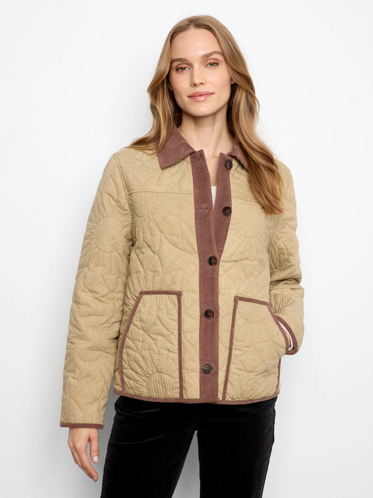 A woman wears a beige quilted jacket, illustrating the plaid jacket vs quilted jacket which is warmer comparison