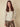 This elegant champagne metallic knit hoodie offers a trendy drawstring hood detail for versatile styling by Charlie B.