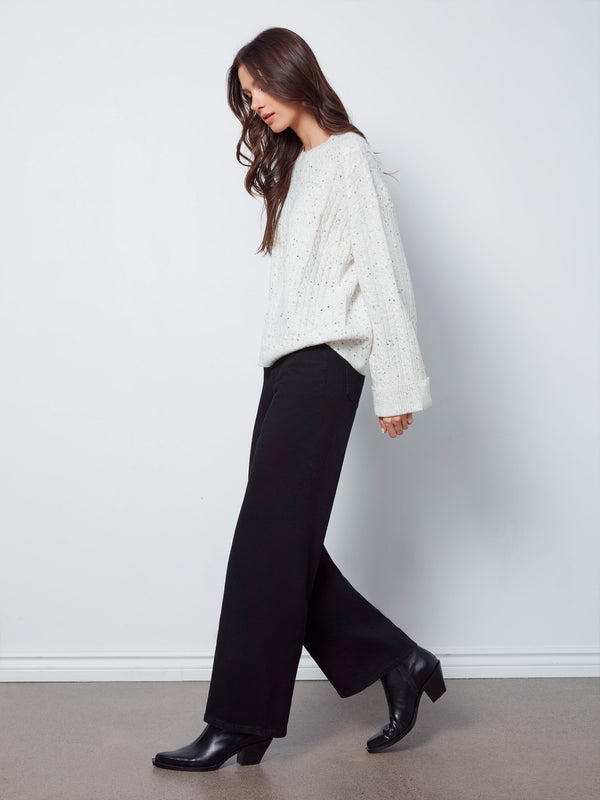 Fashion-forward white sweater with drop shoulders and subtle speckles, effortlessly stylish by Charlie B.