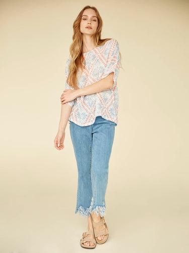 Experience effortless elegance with this lightweight cotton blend top featuring a classic crew neckline and modern silhouette. By Charlie B.
