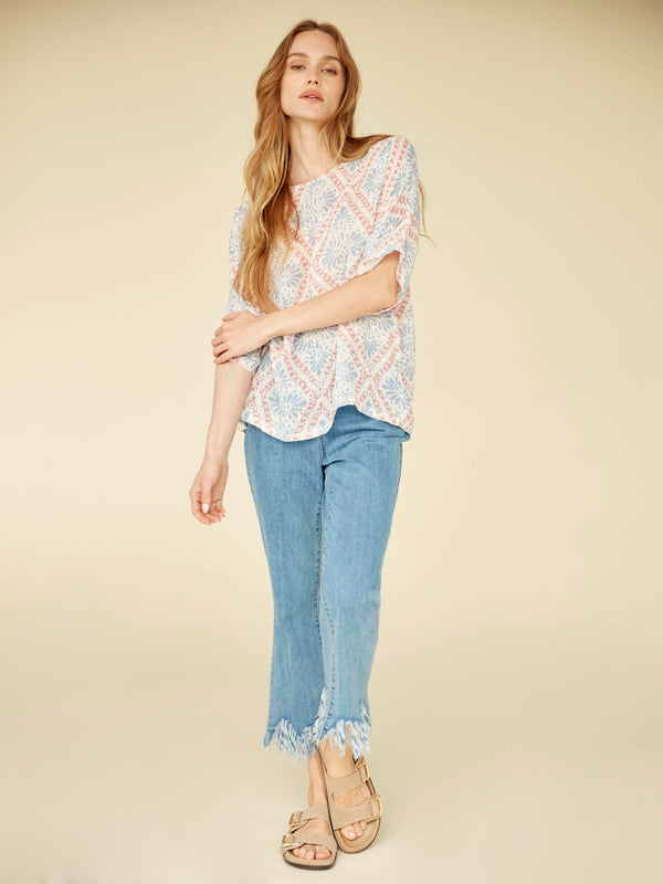 Experience effortless elegance with this lightweight cotton blend top featuring a classic crew neckline and modern silhouette. By Charlie B.