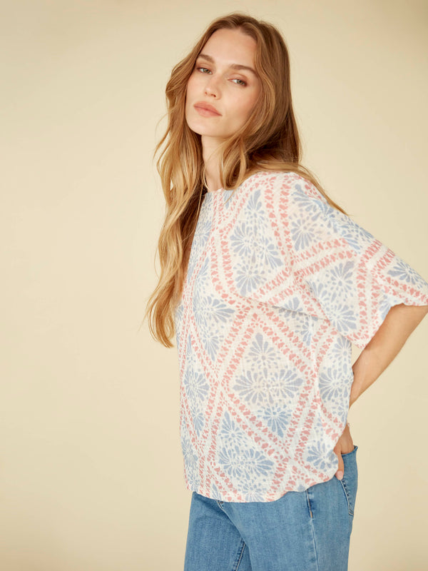 This chic top offers both style and comfort with its relaxed fit design in breathable fabric, complete with elbow-length sleeves. By Charlie B.