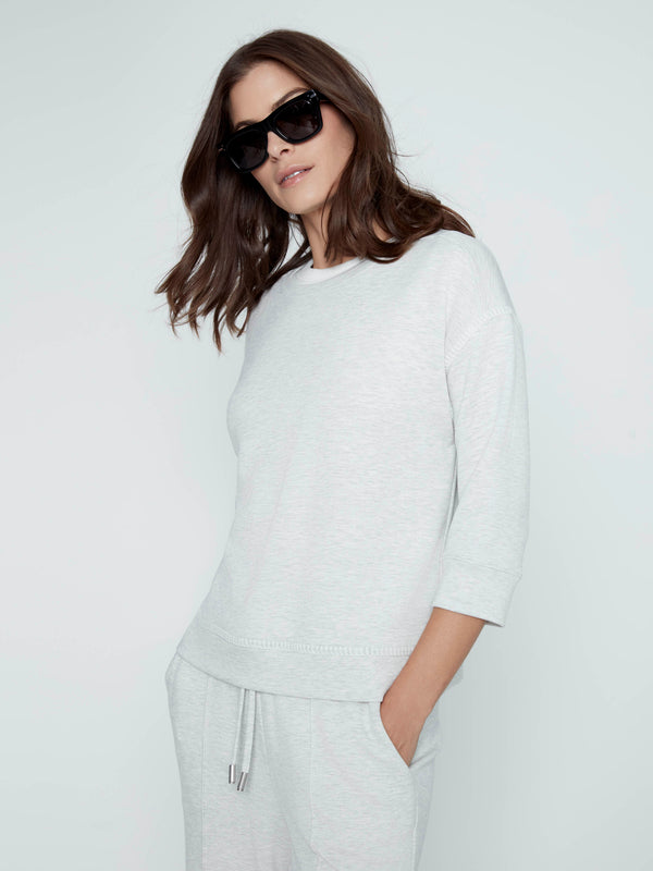 This comfortable top features a classic crew neckline, adding a touch of simplicity and elegance to any casual outfit by Charlie B.