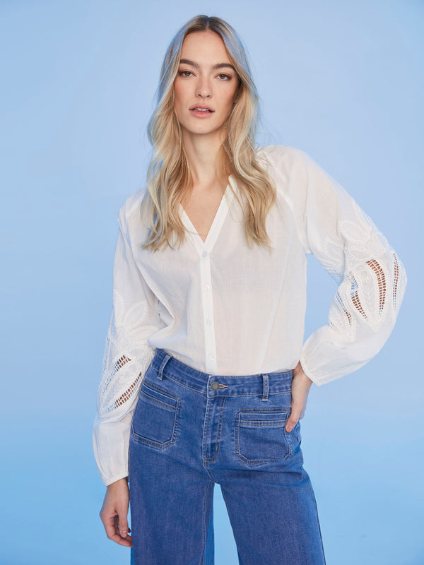 Stylish white blouse designed with a flattering V-neckline by Charlie B.