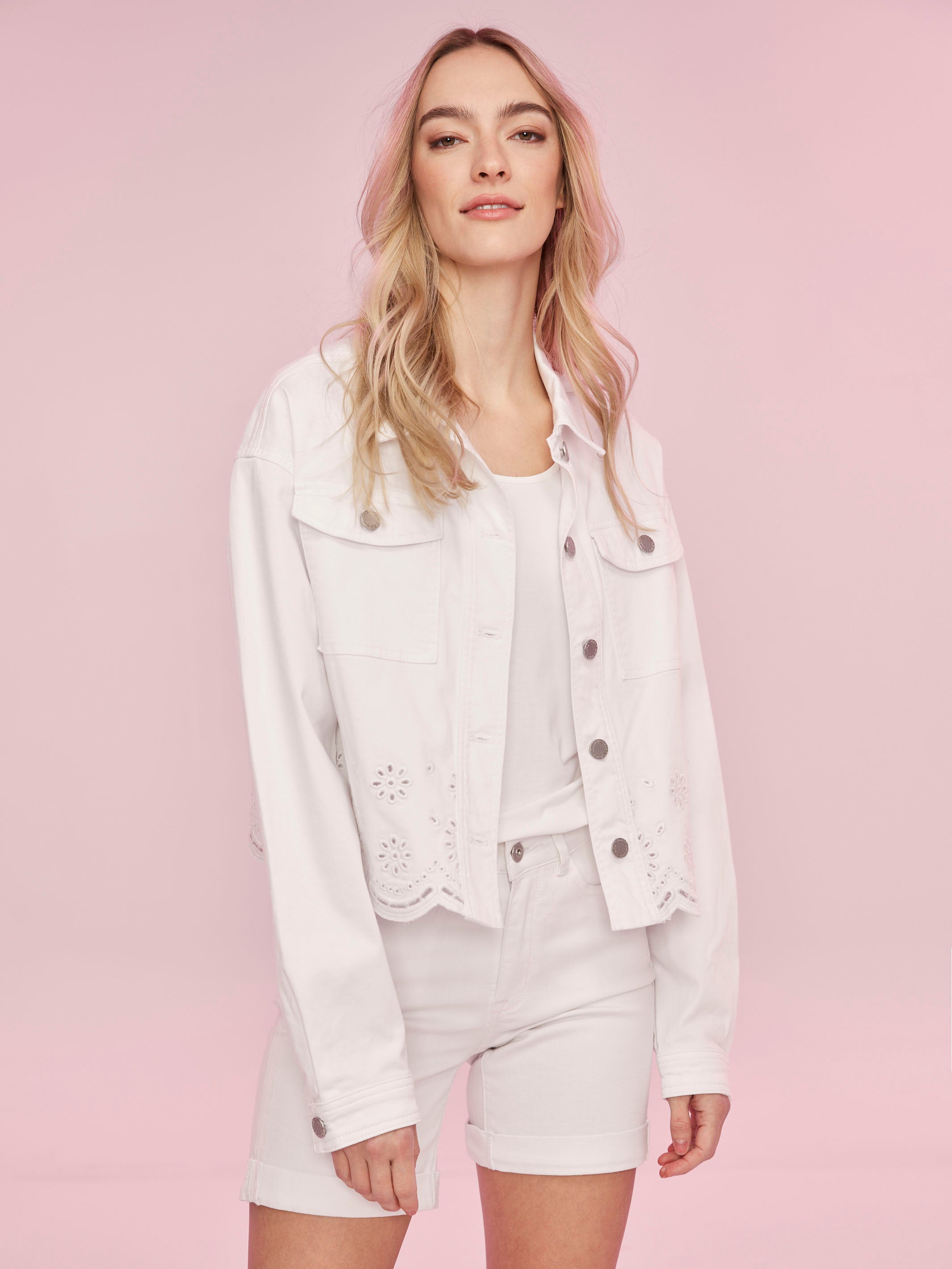 Classic collar and pocket detail on white jacket by Charlie B.
