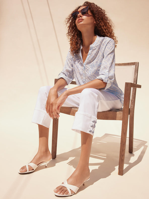 Effortlessly stylish white jeans perfect for summer, highlighting their unique snap button accents by Charlie B.