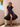 Sophisticated tiered design in a black dress by Charlie B.