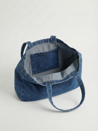 Denim tote showcasing the embossed logo, offering ample space with a 16" length. Designed by Charlie B.