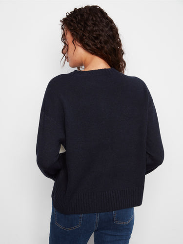 Classic crew neck sweater adorned with a striking argyle pattern and subtle whipstitch accents. A stylish choice by Charlie B.