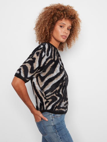The mock neck design enhances the sophisticated look of this soft knit sweater, adding warmth and charm to your wardrobe by Charlie B.