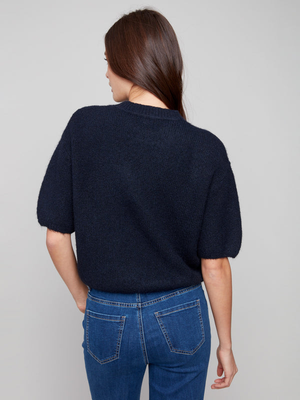 Relaxed fit knit sweater offering effortless style and comfort in soft material by Charlie B.
