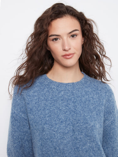 Relaxed fit blue sweater featuring a mock neckline and elegant design by Charlie B.