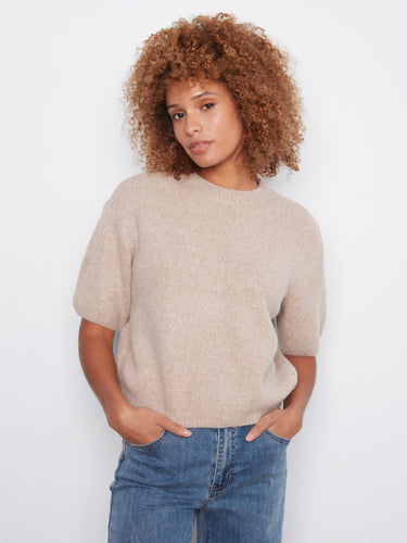 This sweater features a mock neck design, offering a modern and stylish touch to any outfit. By Charlie B.