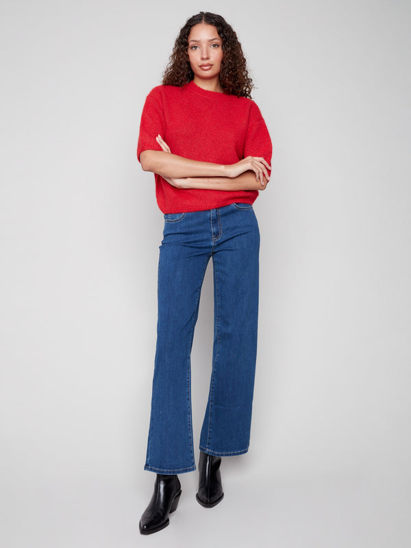 Elegant crimson knit with balloon sleeves and a relaxed silhouette, ideal for stylish comfort by Charlie B.