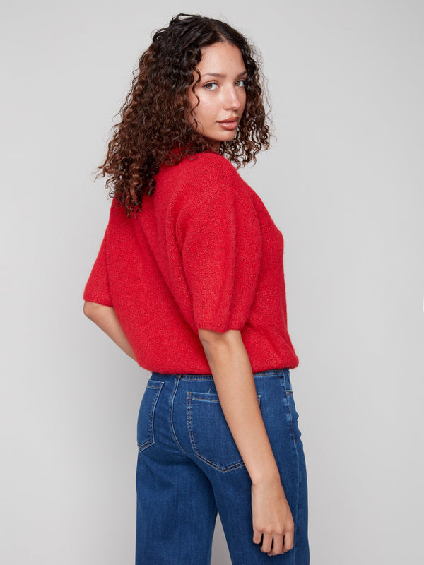 Chic crimson sweater showcasing plush knit fabric and fashionable balloon sleeves for trendsetting style by Charlie B.
