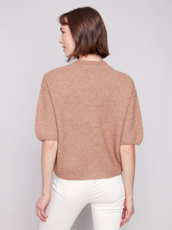 Soft sesame knit sweater showcasing balloon-shaped elbow sleeves for a chic look by Charlie B.