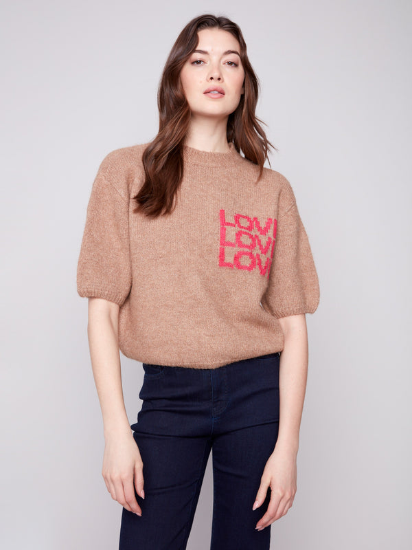 'LOVE' graphic on truffle knit sweater, showcasing a relaxed fit for everyday wear by Charlie B.