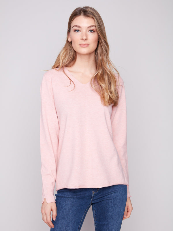 Soft pink sweater with a V neckline and plush texture, offering a cozy feel perfect for cool days by Charlie B.