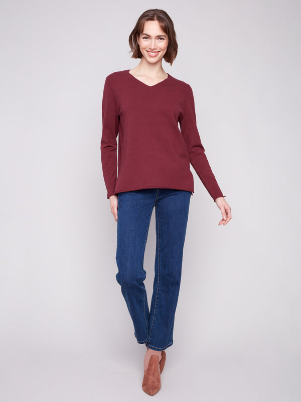 Experience the elegance of long sleeves in this classic Cabernet sweater by Charlie B.