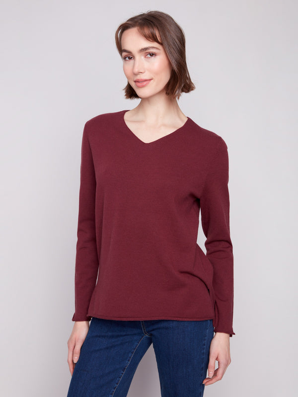 This Cabernet sweater features side slits on sleeves and hem, adding a trendy touch by Charlie B.