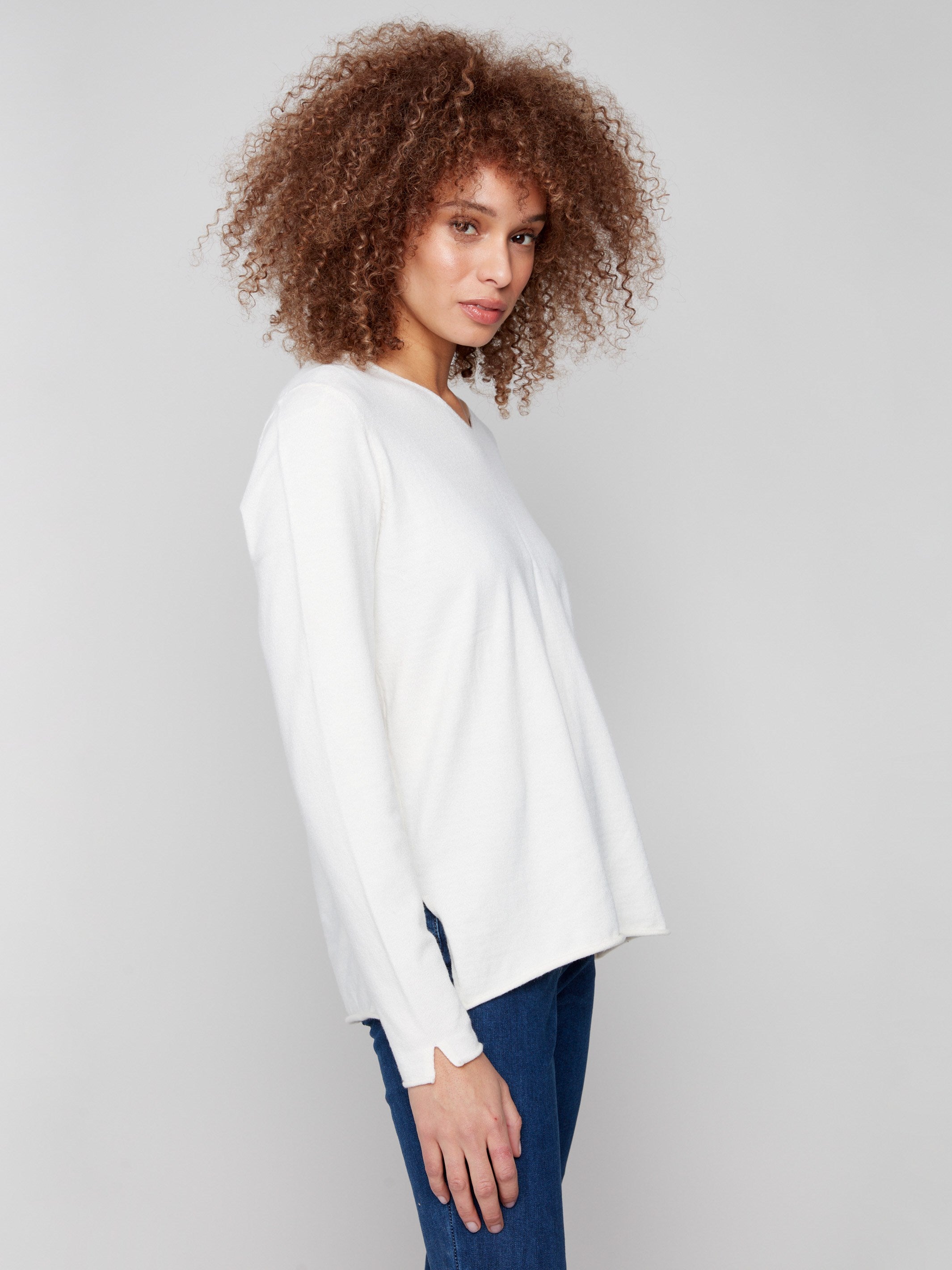 Elegant ecru sweater showcasing long sleeves and a refined plush texture, perfect for any occasion by Charlie B.