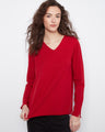 Red top with a V-neckline and long sleeves, crafted for comfort and elegance. By Charlie B.