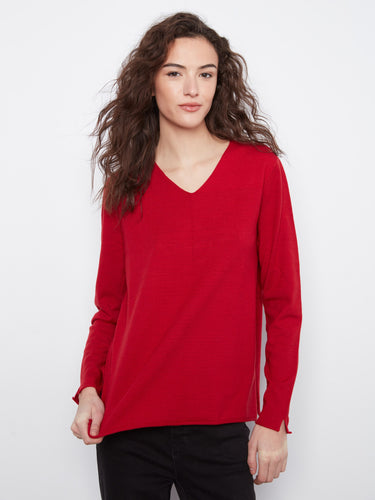 Red top with a V-neckline and long sleeves, crafted for comfort and elegance. By Charlie B.