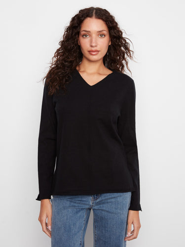 Black V-neck sweater featuring side slits for a modern touch by Charlie B.