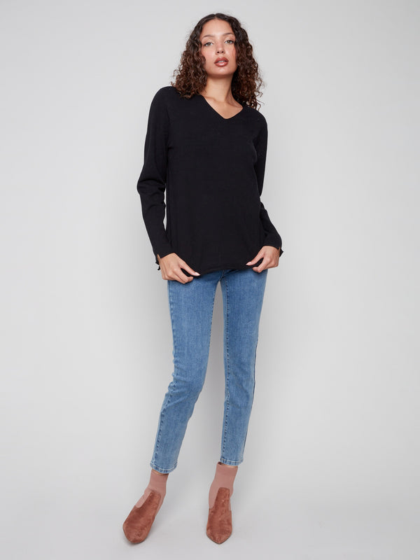 Chic black sweater featuring long sleeves and a comfortable fit, perfect for any occasion by Charlie B.