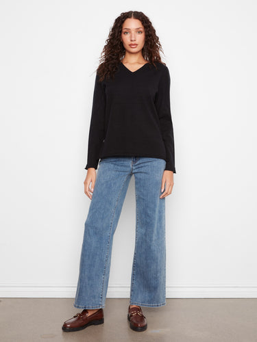 Long sleeve black sweater with a classic V-neckline and timeless appeal by Charlie B.