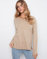 Beige top with a flattering V-neckline, perfect for layering or wearing alone. Crafted from soft knit fabric for comfort by Charlie B.