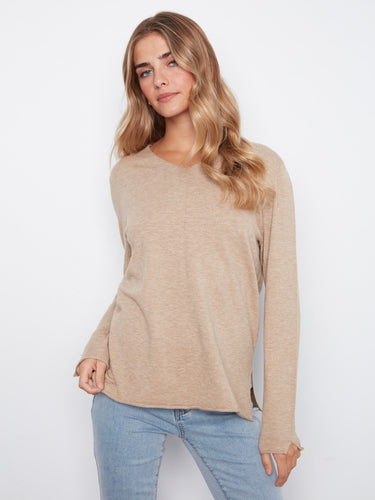 Beige top with a flattering V-neckline, perfect for layering or wearing alone. Crafted from soft knit fabric for comfort by Charlie B.