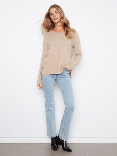 Embrace the cozy feel of this soft knit top with side slits, adding a touch of elegance to your everyday wardrobe by Charlie B.