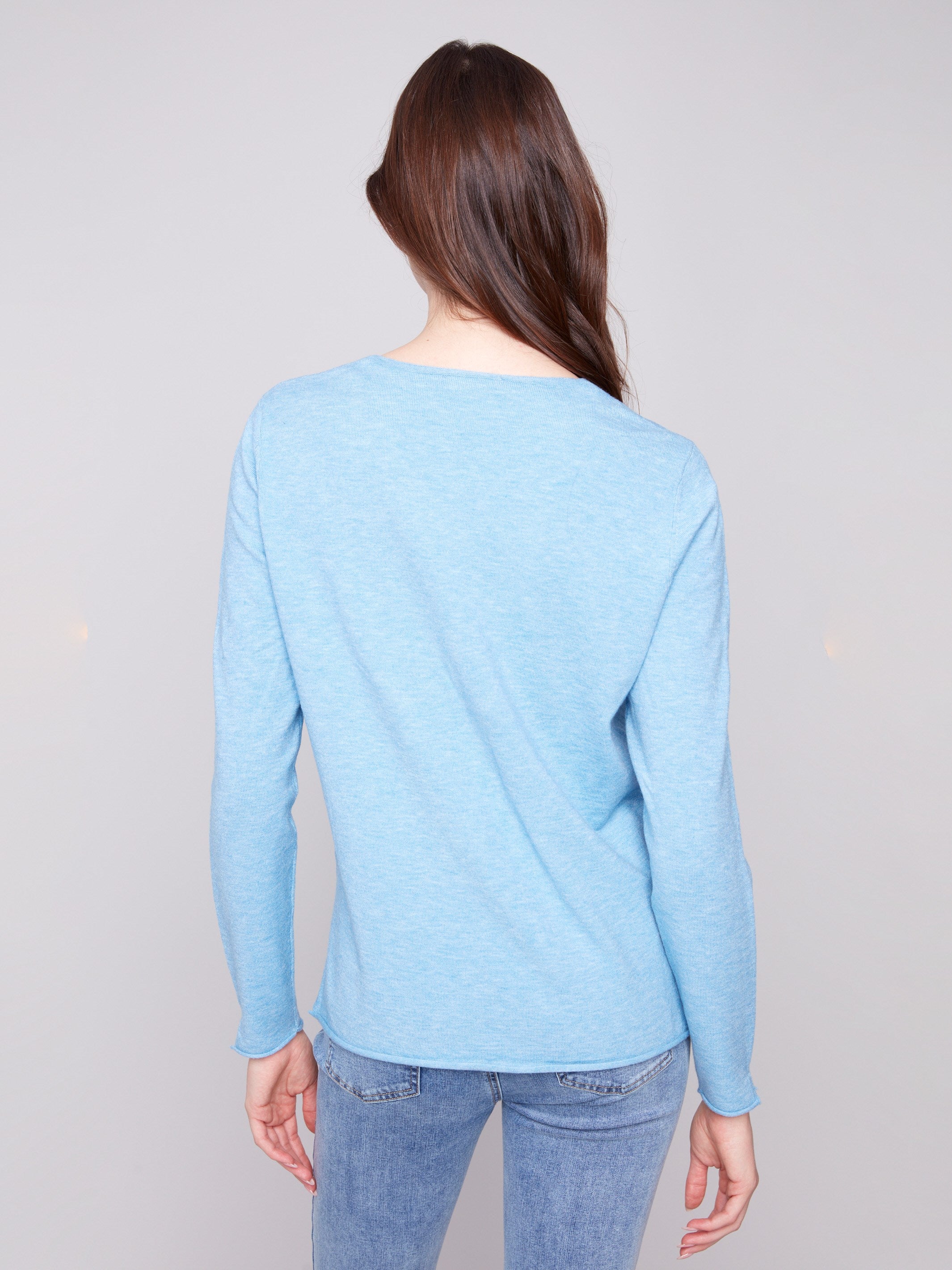 Side slits on the sleeves and hem add a touch of flair to this versatile V-neck piece by Charlie B.