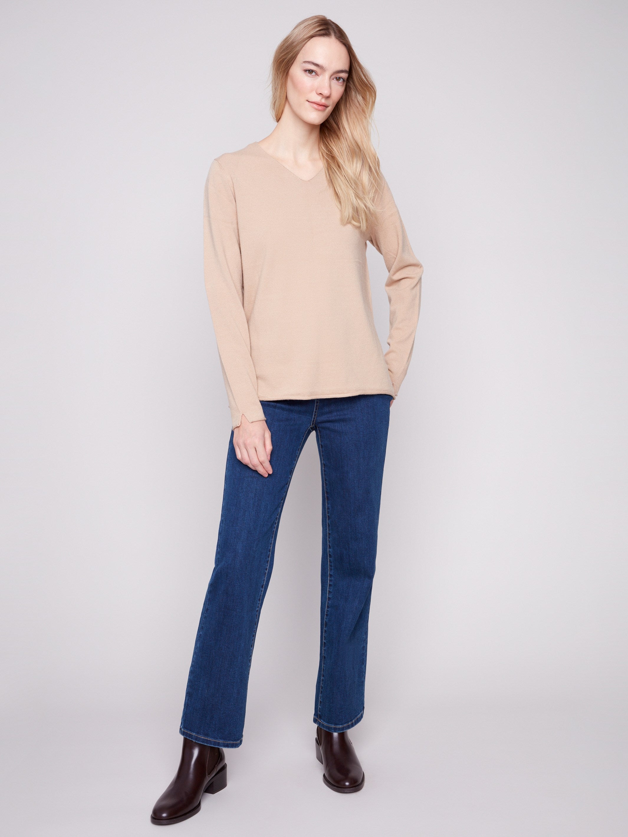 Elegant sesame V-neck sweater featuring side slits on sleeves and hem for added flair by Charlie B.