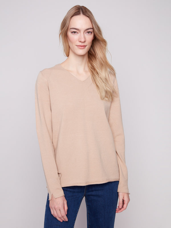 Plush V-neck sesame sweater designed with side slits on the hem, perfect for versatile styling by Charlie B.