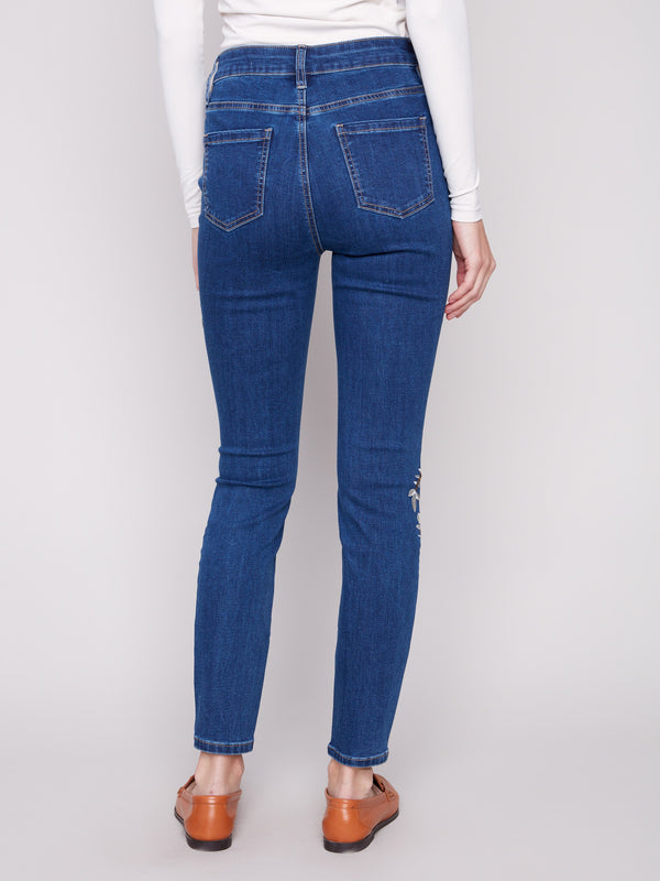 Five-pocket design indigo jeans enriched with beautiful embroidered patterns for a trendy appeal by Charlie B.