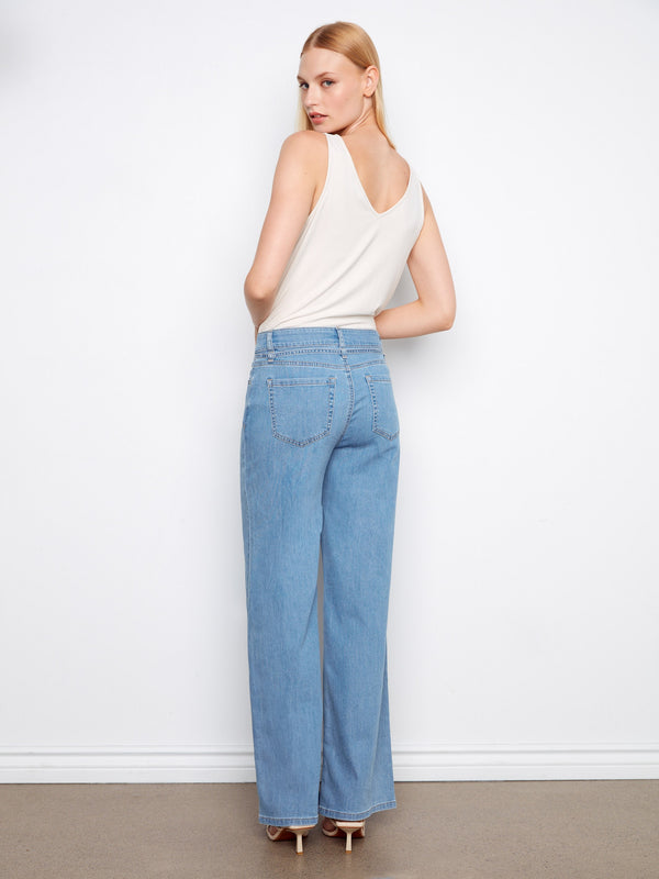 The long length of these jeans creates an elegant and elongated silhouette suitable for various occasions. By Charlie B.
