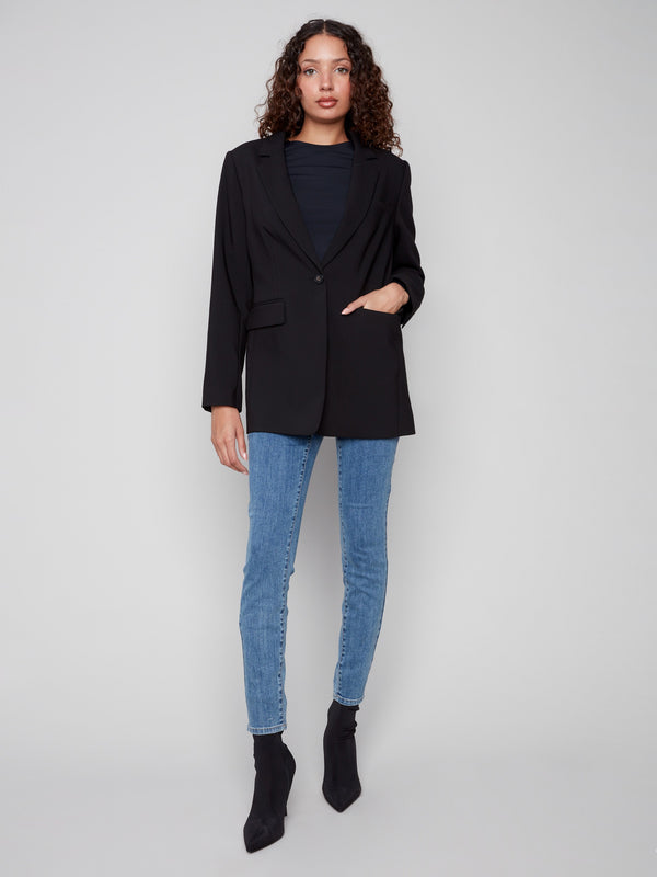 Black blazer featuring long sleeves with buttoned cuffs, tailored for a sleek look by Charlie B.
