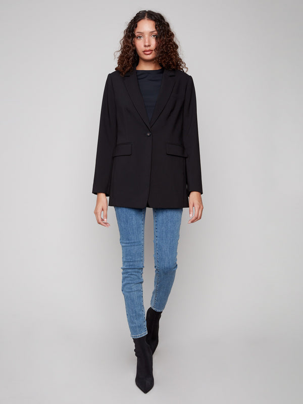 Chic black blazer designed with front flap pockets and a tailored fit by Charlie B.