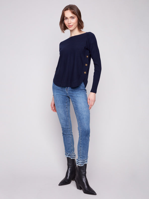 Featuring chic side button details, this navy sweater offers a unique twist on a classic look by Charlie B.