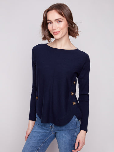 The rounded hem of this navy sweater adds a modern flair, perfect for versatile styling options by Charlie B.