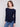 The rounded hem of this navy sweater adds a modern flair, perfect for versatile styling options by Charlie B.