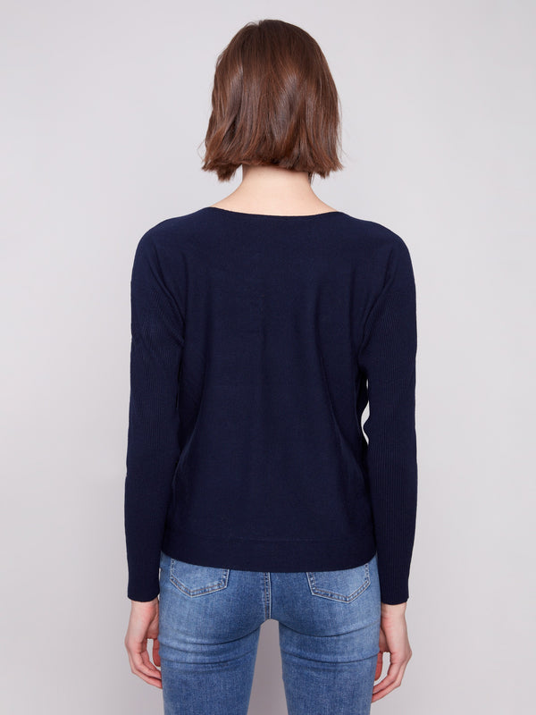 Ribbed sleeves enhance the comfort and fit of this elegant navy sweater, making it perfect for any occasion by Charlie B.