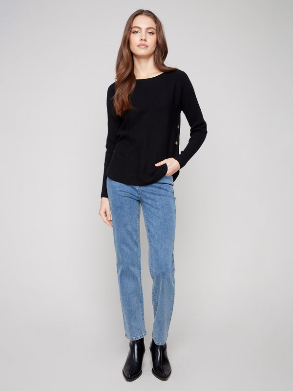 Chic black sweater showcasing side button details, perfect for adding a stylish touch to any outfit by Charlie B.
