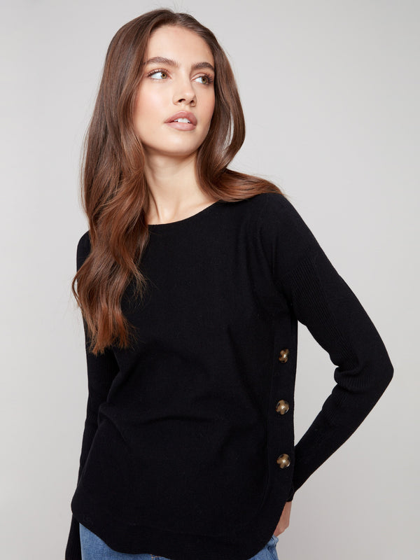 Stylish black sweater with a rounded hem, offering a flattering silhouette for versatile wear by Charlie B.