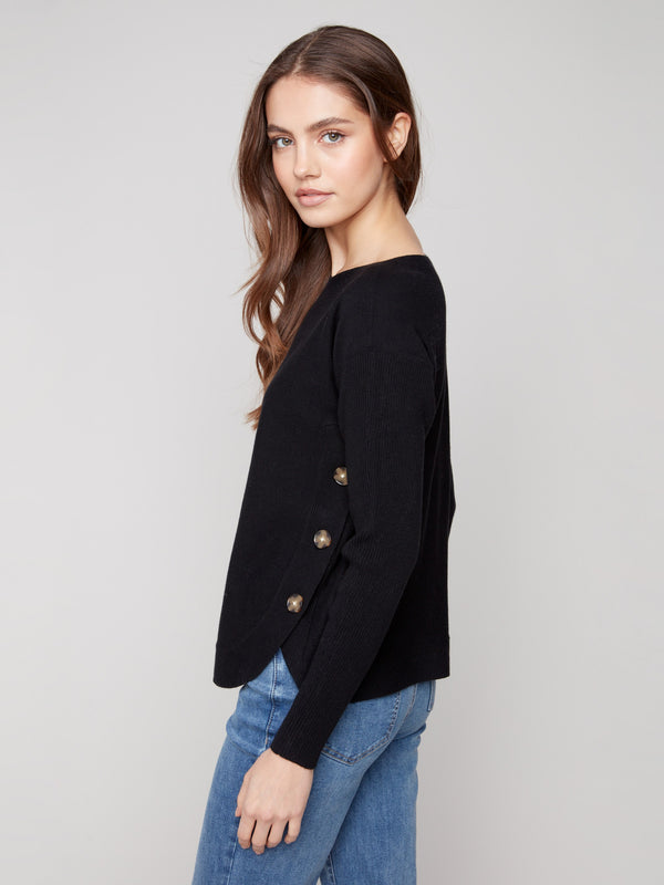 Black long-sleeve sweater featuring ribbed sleeves, providing comfort and style in equal measure by Charlie B.