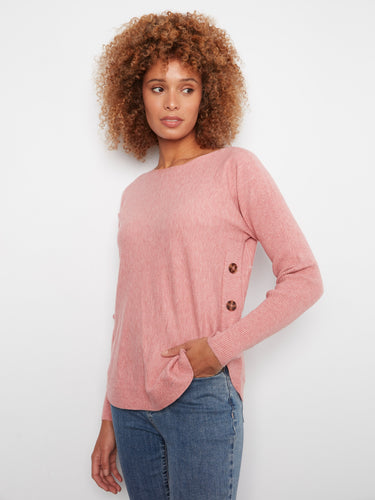 Chic pink sweater showcasing ribbed sleeves for a cozy and fashionable look by Charlie B.