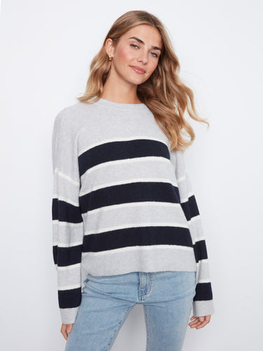 This sweater features a classic crew neckline, perfect for a comfortable and relaxed look. By Charlie B.