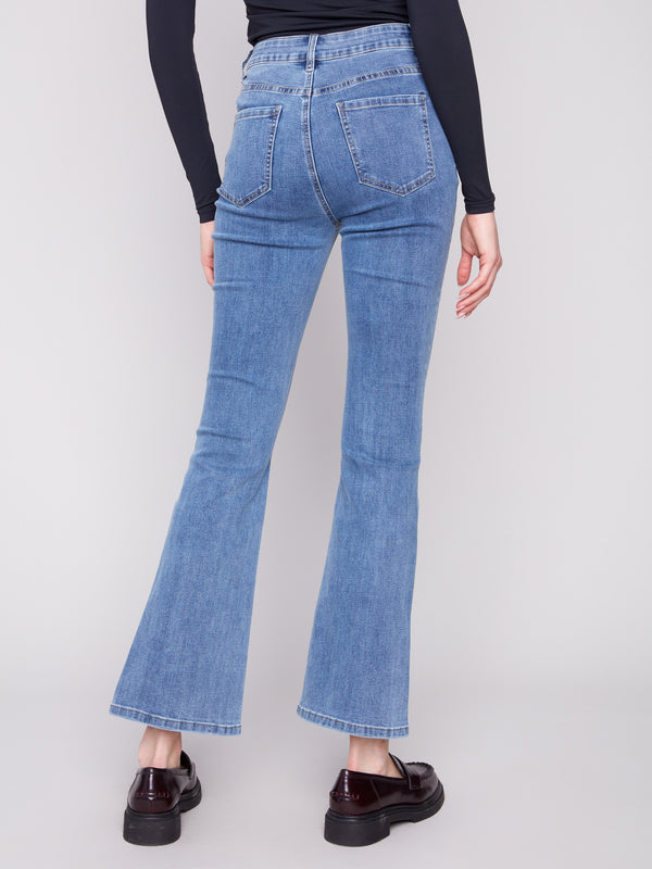 Designed with a five-pocket style, these medium blue bootcut jeans offer both functionality and style by Charlie B.